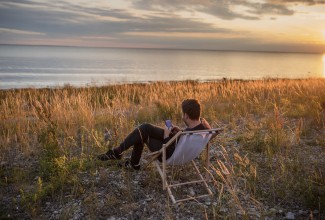 Man at the seaside using mobile phone